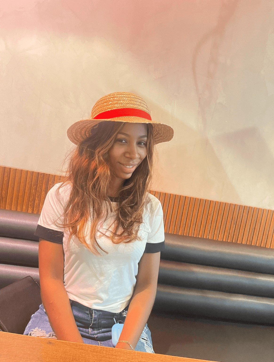 Dhanibel Reyes smiling in a straw hat